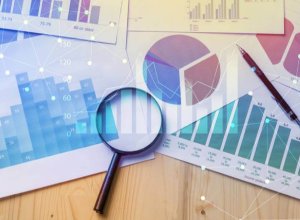 magnifying glass with financial statements